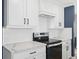 White shaker cabinets, quartz countertops, and herringbone backsplash in this kitchen at 2966 Great Abaco Way, Bradenton, FL 34208