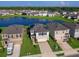 Aerial view of a two-story house with solar panels, a two-car garage and a landscaped yard at 2966 Great Abaco Way, Bradenton, FL 34208