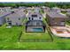 An aerial view of a house with a screened-in pool and solar panels at 2966 Great Abaco Way, Bradenton, FL 34208