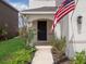 Inviting front entry with walkway and American flag at 2966 Great Abaco Way, Bradenton, FL 34208