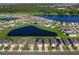 Aerial view of a community with houses around a lake at 2966 Great Abaco Way, Bradenton, FL 34208