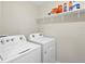 Laundry room with washer, dryer, and shelf for storage at 2966 Great Abaco Way, Bradenton, FL 34208