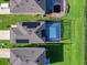 Aerial view of a screened-in pool and solar panels on the house at 2966 Great Abaco Way, Bradenton, FL 34208