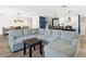Open concept living area with sectional sofa and views to the kitchen at 2966 Great Abaco Way, Bradenton, FL 34208