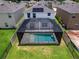 An aerial view of a house with a screened-in pool and solar panels at 2966 Great Abaco Way, Bradenton, FL 34208