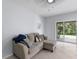 Living room with beige sectional sofa and sliding glass door at 14813 Skip Jack Loop, Lakewood Ranch, FL 34202