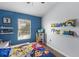 Bright bedroom with built-in shelving and a Paw Patrol-themed bed at 14813 Skip Jack Loop, Lakewood Ranch, FL 34202