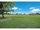 Large grassy park area with trees and white fence at 14813 Skip Jack Loop, Lakewood Ranch, FL 34202