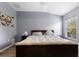 Spacious bedroom with king-size bed and large window providing natural light at 14813 Skip Jack Loop, Lakewood Ranch, FL 34202