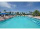 Inviting resort-style pool with plenty of lounge chairs and umbrellas at 1045 Gulf Of Mexico Dr # 403, Longboat Key, FL 34228