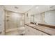 Guest bathroom with walk-in shower and granite vanity at 1045 Gulf Of Mexico Dr # 403, Longboat Key, FL 34228