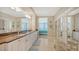 Double vanity bathroom with granite countertops and walk-in closet at 1045 Gulf Of Mexico Dr # 403, Longboat Key, FL 34228