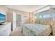 Guest bedroom with a queen bed, dresser, and ocean view at 1045 Gulf Of Mexico Dr # 403, Longboat Key, FL 34228