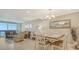 Dining area with table and chairs, ocean view from nearby living room at 1045 Gulf Of Mexico Dr # 403, Longboat Key, FL 34228