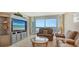 Living room with ocean view, comfortable seating, and entertainment center at 1045 Gulf Of Mexico Dr # 403, Longboat Key, FL 34228