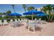Community patio area with tables, chairs and umbrellas at 1045 Gulf Of Mexico Dr # 403, Longboat Key, FL 34228