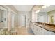 Double vanity bathroom with granite countertops and large mirrors at 1045 Gulf Of Mexico Dr # 403, Longboat Key, FL 34228