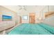 King-size bed, dresser, TV, and access to bathroom and kitchen at 1045 Gulf Of Mexico Dr # 403, Longboat Key, FL 34228