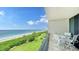Balcony with table and chairs overlooking the beach and ocean at 1045 Gulf Of Mexico Dr # 403, Longboat Key, FL 34228
