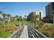 Aerial view of a community with palm trees, grass, and a boardwalk path at 1045 Gulf Of Mexico Dr # 403, Longboat Key, FL 34228