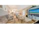 Open living area with comfortable seating and view into dining area at 1045 Gulf Of Mexico Dr # 403, Longboat Key, FL 34228