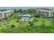 Aerial view of community with resort-style pool, lush landscaping, and bayfront location at 1045 Gulf Of Mexico Dr # 403, Longboat Key, FL 34228