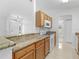 Kitchen with wood cabinets, granite countertops, and white appliances at 2318 N Chamberlain Blvd, North Port, FL 34286