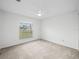 Bright bedroom featuring carpet flooring and a window at 2318 N Chamberlain Blvd, North Port, FL 34286