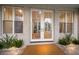 Front entrance with double doors, a rug and flanking plants at 102 75Th St, Holmes Beach, FL 34217