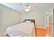 Cozy bedroom featuring a queen-sized bed, wood floors, and a ceiling fan at 11622 Summit Rock Ct, Parrish, FL 34219
