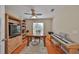 Comfortable bonus room with hardwood floors, a ceiling fan, built-in shelves, and a keyboard at 11622 Summit Rock Ct, Parrish, FL 34219