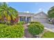 Charming single-story home featuring a well-manicured lawn, two-car garage, and colorful landscaping at 11622 Summit Rock Ct, Parrish, FL 34219