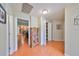 Hallway leads to kitchen, pantry and other rooms with hardwood flooring at 11622 Summit Rock Ct, Parrish, FL 34219