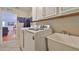 Functional laundry room features a washing machine, utility sink and bright white cabinets at 11622 Summit Rock Ct, Parrish, FL 34219