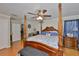 Spacious main bedroom features a four-poster bed, ceiling fan and ensuite bathroom at 11622 Summit Rock Ct, Parrish, FL 34219