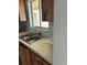Simple kitchen with double sink and wood cabinets at 3780 Lake Bayshore Dr # K-521, Bradenton, FL 34205