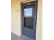 Exterior condo entry with a dark gray screen door at 3780 Lake Bayshore Dr # K-521, Bradenton, FL 34205