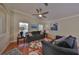 Living room with hardwood floors, gray sofas, and a ceiling fan at 11622 Summit Rock Ct, Parrish, FL 34219