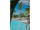 Beautiful pool area with palm trees and lounge chairs offers a relaxing retreat at 12240 Wellen Golf St # 301, Venice, FL 34293