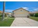 Charming single-story home featuring a two-car garage, well-manicured lawn, and a beautiful blue sky at 4223 Murfield E Dr, Bradenton, FL 34203