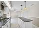 Stylish kitchen with white cabinets, black countertops, and an island offering plenty of storage at 4223 Murfield E Dr, Bradenton, FL 34203