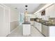Modern kitchen with stainless steel appliances, black countertops, and an island for additional workspace at 4223 Murfield E Dr, Bradenton, FL 34203