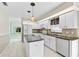 Well-lit kitchen with white cabinetry, granite countertops, and a functional island at 4223 Murfield E Dr, Bradenton, FL 34203