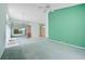Open living room with vaulted ceiling, mirror, and entry to front of house at 4223 Murfield E Dr, Bradenton, FL 34203