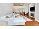 Two-story living room with hardwood floors, fireplace, and sectional sofa at 1711 Starling Dr # 1711, Sarasota, FL 34231