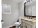 Charming powder room with decorative vanity and a beige countertop at 1711 Starling Dr # 1711, Sarasota, FL 34231
