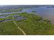 Aerial view showing waterfront property with lush mangrove trees and access to the waterway at 1711 Starling Dr # 1711, Sarasota, FL 34231