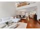 Open living space with hardwood floors, sectional sofa and view of the dining area at 1711 Starling Dr # 1711, Sarasota, FL 34231