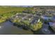 Aerial view of community tennis courts, pool, and pond at 1711 Starling Dr # 1711, Sarasota, FL 34231