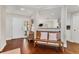 Bright entryway with hardwood floors, bench, and view into the kitchen at 1711 Starling Dr # 1711, Sarasota, FL 34231